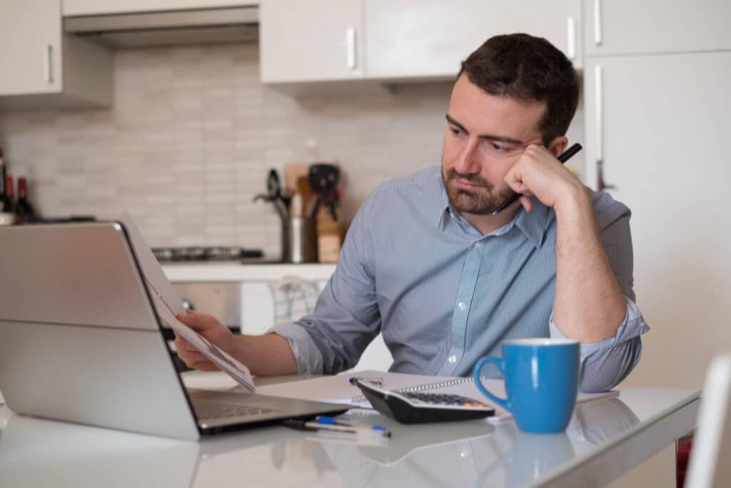 Frustrated man calculating bills and expenses- Sprint Funding