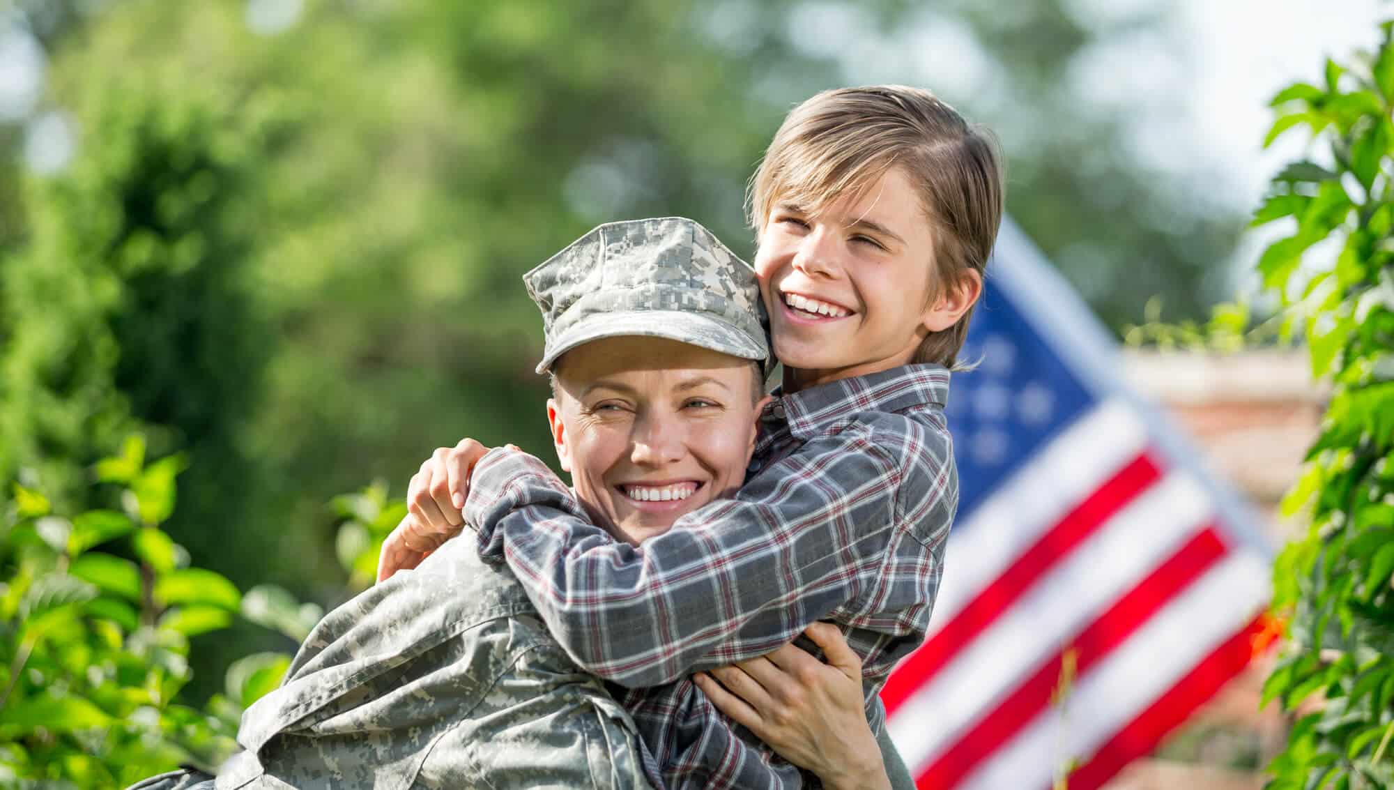 Female veteran army hugging her son - Sprint Funding