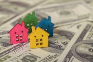 The combination of colors and shapes in the houses symbolizes the variety of choices available in the housing market.