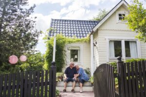 couple sitting on the steps of newly purchased house